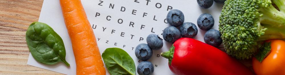 Veggies and fruits over a Snellen eye chart.