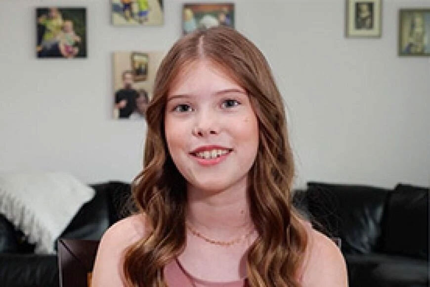 Photograph of a girl smiling.