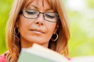 middle aged woman reading book