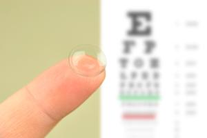 A contact lens in front of an eye chart.