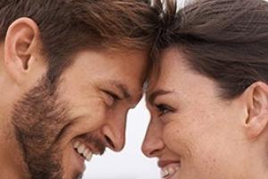 Couple making eye contact and smiling.