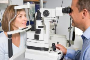 A woman at an eye exam appointment with an optometrist.
