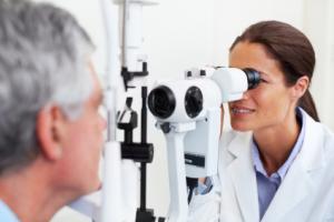 A man getting his eyes examined by an optometrist.