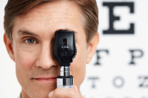 An optometrist in front of an eye chart.