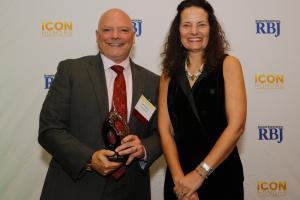 CooperVision's Jerry Warner receives an award for his leadership and support of the Greater Rochester community.
