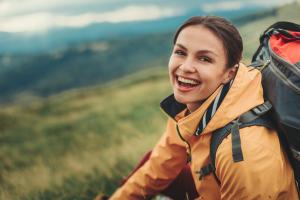 smiling young woman outside while hiking