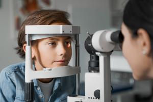 A boy in an optometric practice getting an eye exam.