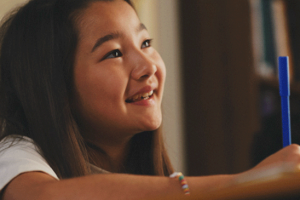 girl writing in school