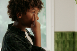 child inserting contact lens