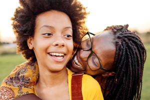 mom hugging child outdoor