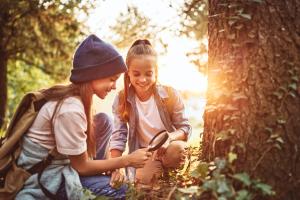 Two girls enjoying time outside and exploring nature.