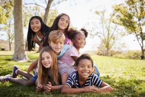 Group of happy, older children outside.