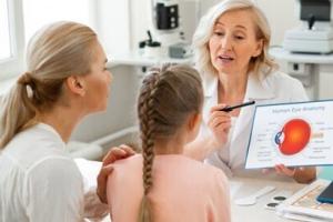 cropped photo of mother and daughter talking to their optometrists about vision and eye health.