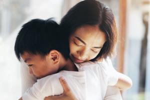 A mother hugging her young son