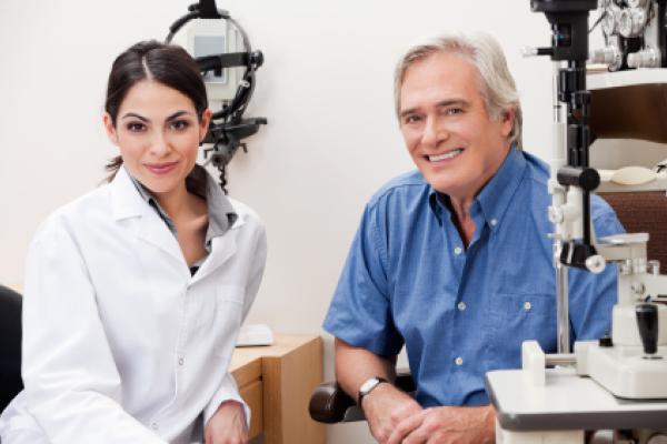 Smiling female optometrist with patient
