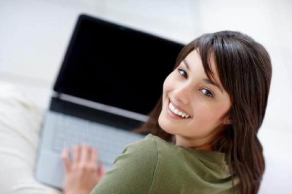 Smiling girl on laptop