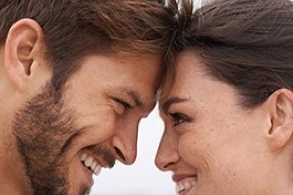 Couple making eye contact and smiling.