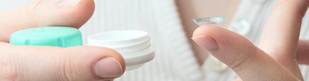 person holding contact lens and case