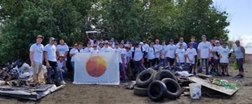 CooperVision team members pose with collected debris following the International Coastal Cleanup in Juana Diaz, Puerto Rico.