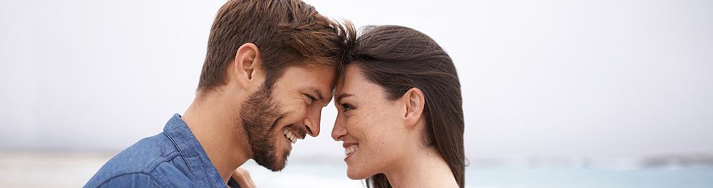 couple making eye contact and smiling.