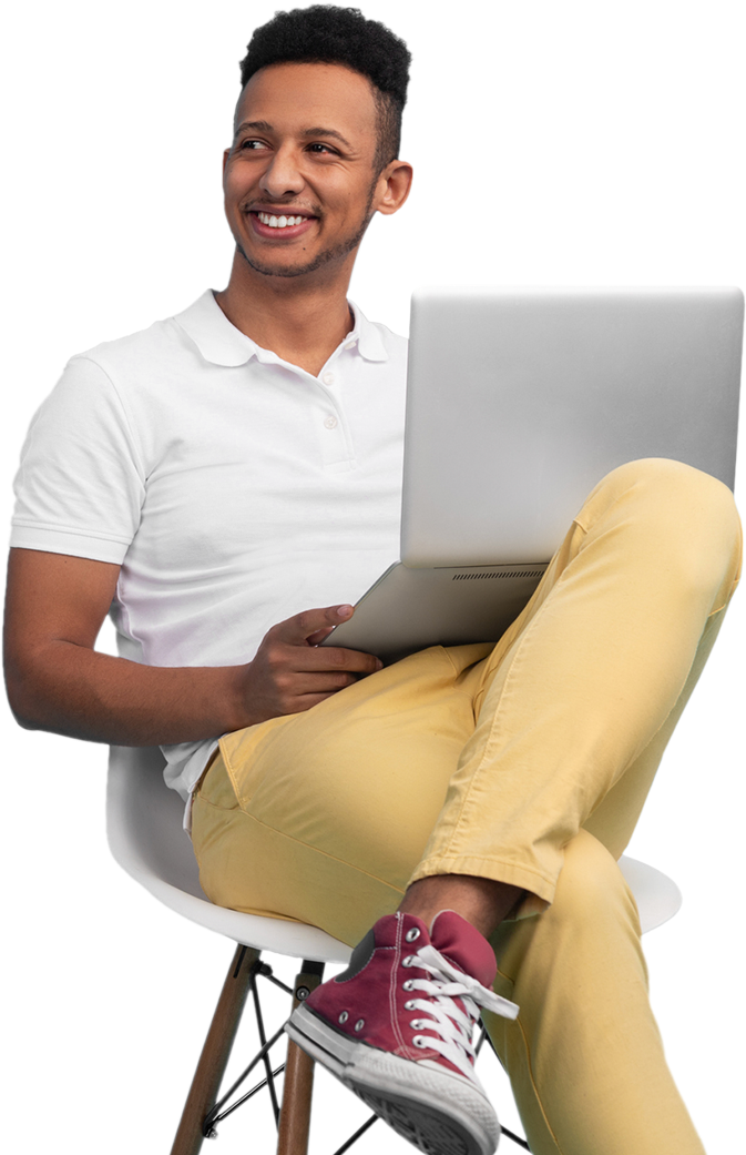 man smiling and holding a laptop