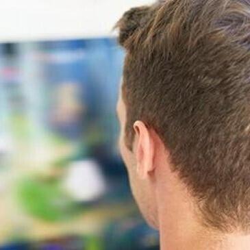 Man looking at blurry screen