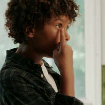 kid inserting contact lenses