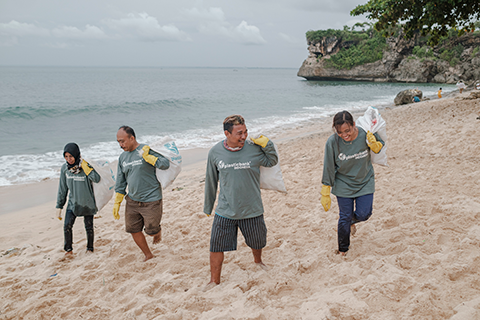 a group of people cleaning the beach