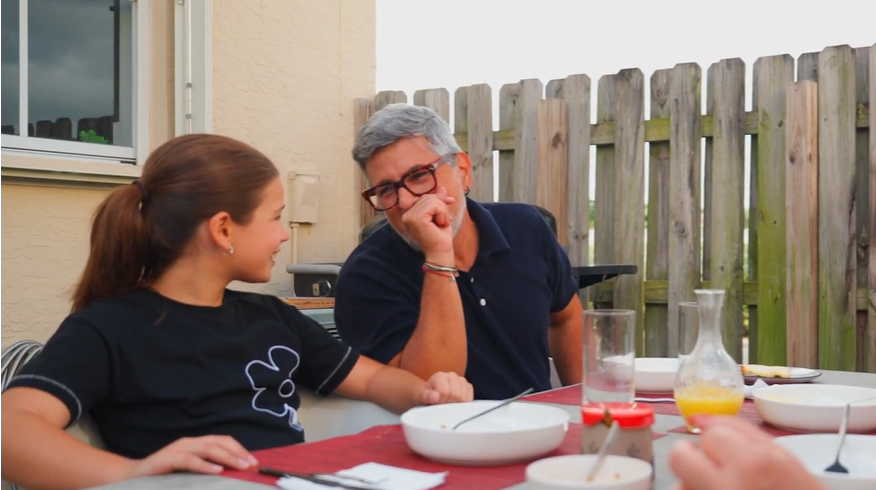 Picture of father and daughter outside smiling and talking