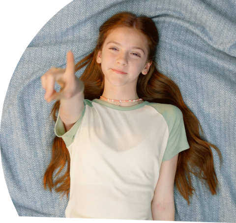 girl on blanket point to sky