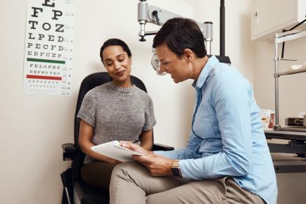 female millennial talking to her female optometrist during an eye exam