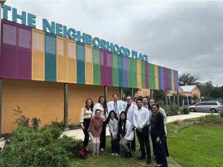 group of optometry school students smiling outside in a group picture
