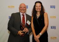 CooperVision's Jerry Warner receives an award for his leadership and support of the Greater Rochester community.
