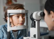 A boy in an optometric practice getting an eye exam.