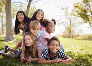 Group of happy, older children outside.