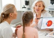 cropped photo of mother and daughter talking to their optometrists about vision and eye health.