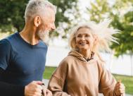 A happy middle-aged couple running