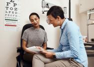 female millennial talking to her female optometrist during an eye exam