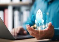 businessman touching virtual rocket indicating rapid business growth